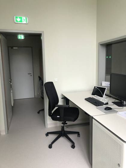 Fitted furniture with a monitor and a signal panel.